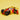 shows the ninjago character kai minifigure resting next to the race car.