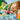 shows a young child playing with the red car and boy minifigure surrounded by other lego pieces.