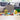 shows pieces of the built lego, a red car, a yellow arch, a treehouse, a slide and the figures of a boy, girl and dog.