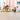 shows 2 kids playing with the fully built lego set on the floor.