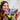 shows a close up of a woman smiling next to the fully built wildflower bouquet.