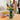 shows the wildflower bouquet in a transparent vase displayed on a dining table.