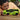 LEGO technic 42161 lamborghini huracan 806 piece set. shows a child holding up the fully built neon green technic lamborghini.