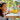 lego creator 31149 flowers in watering can 420 piece set. shows a young girl holding the fully built lego set flowers in watering can.