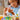 lego classic 11034 creative pets. shows a child holding the cat figure in her palm.