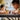 lego ninjago 71804 arins battle mech. shows a father and daughter playing with the fully built mech and minifigures.
