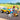 Lego Friends 42635 Dog Grooming Car. Shows the 2 mini figures and dog figures tanding by the dog grooming car.