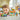 Lego Friends 42625 Beach Smoothie Stand. Shows a young girl playing with the fully built beach smoothie stand, car and mini figures.