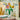 Lego Botanicals 10347 Petite Sunny Bouquet 373 piece set. Shows the bouquet displayed in a transparent vase on a coffee table.